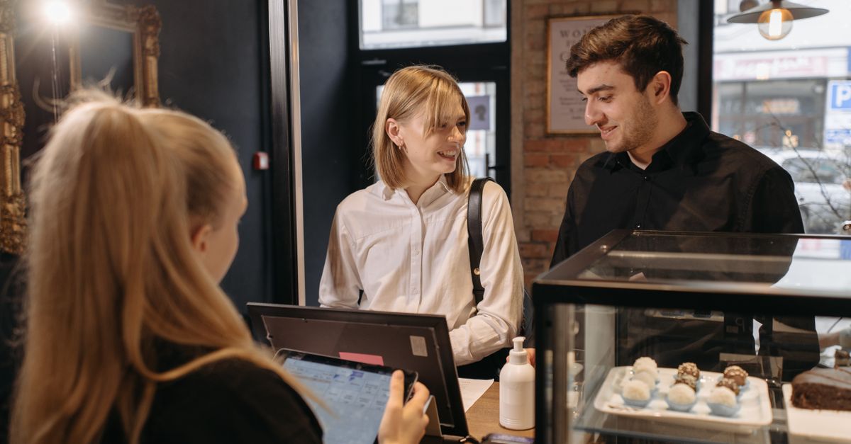 A returning customer being welcomed at a local service business